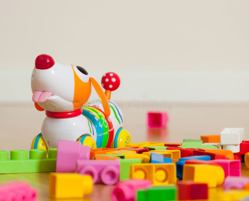 Cute dog toy between rubber toy blocks royalty free stock images Cute dog toy between rubber toy blocks royalty free stock images