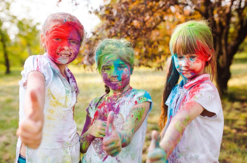 Cute european child girls celebrate Indian holi festival with colorful paint powder on faces and body royalty free stock photography Cute european child girls celebrate Indian holi festival with colorful paint powder on faces and body royalty free stock photography