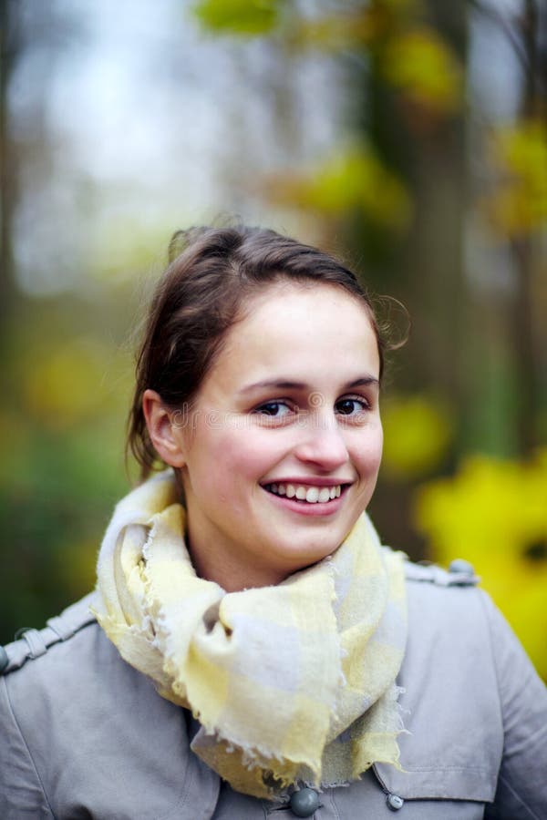 Cute fashionable young woman smiling at you