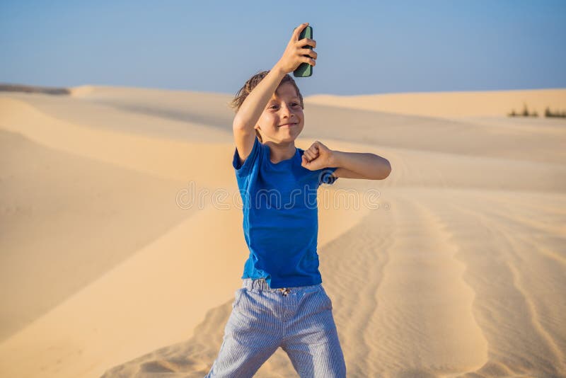 Cute Funny Boy in Dance with a Smartphone in His Hands in the Desert Stock  Image - Image of performance, young: 214796511