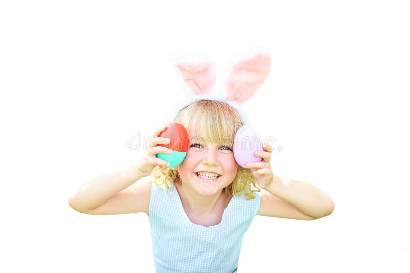 Cute funny girl with Easter eggs and bunny ears at garden. easter concept. Laughing child at Easter egg hunt