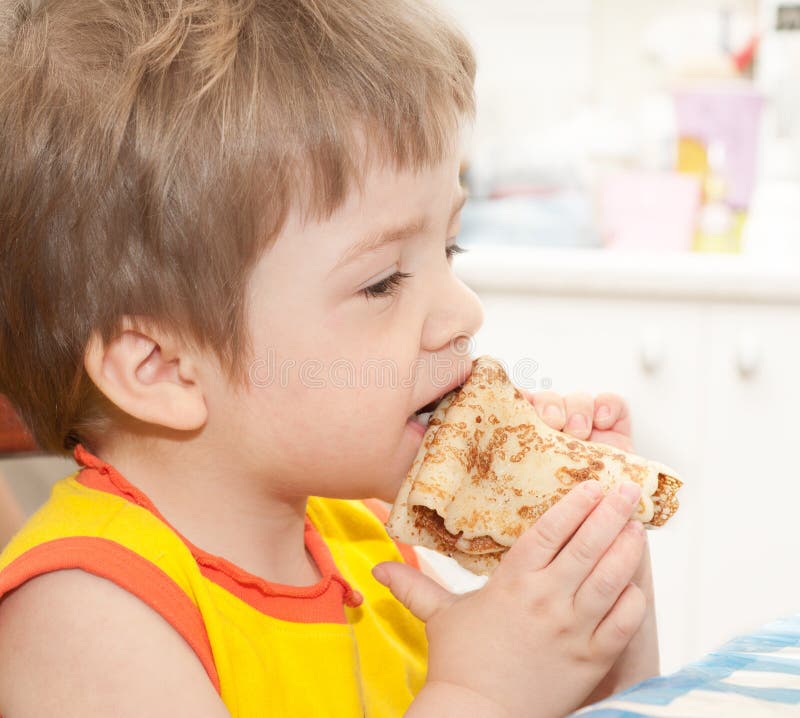 Cute girl eating pancake stock image. Image of blond 22975385