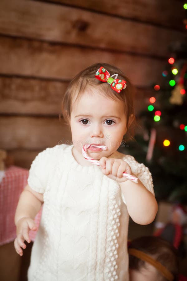 Child eating a candy cane stock photo. Image of holiday 28077240
