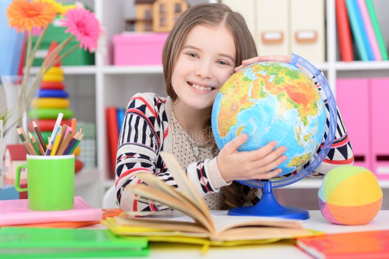 Cute girl embracing a globe