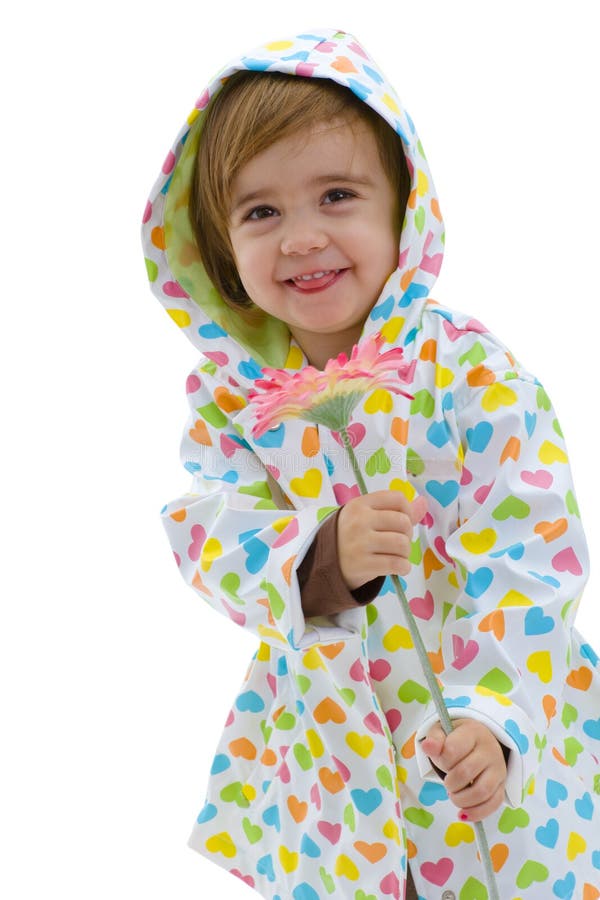 Happy girl child wearing raincoat and boots, holding pink flower. Isolated on white background. Lovely european female stock images, royalty-free photos and pictures