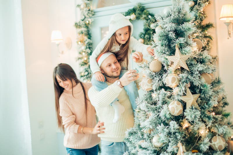 Happy girl decorating Christmas tree.Family, christmas, ,happiness concept stock image Happy girl decorating Christmas tree.Family, christmas, ,happiness concept stock image