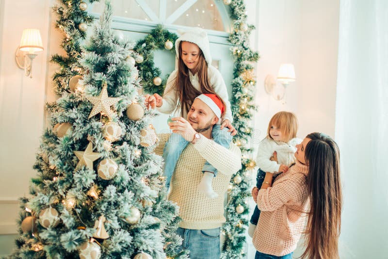 Happy girl decorating Christmas tree.Family, christmas, ,happiness concept stock image Happy girl decorating Christmas tree.Family, christmas, ,happiness concept stock image
