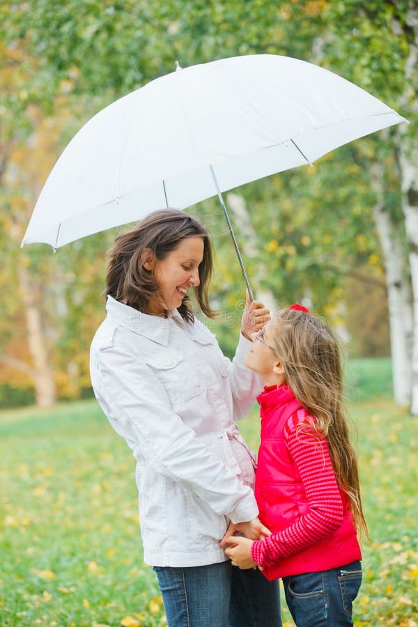 Cute girl with her mother walking in park