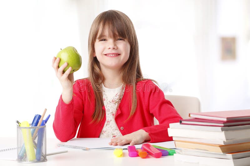 Cute girl holding an apple royalty free stock photography Cute girl holding an apple royalty free stock photography