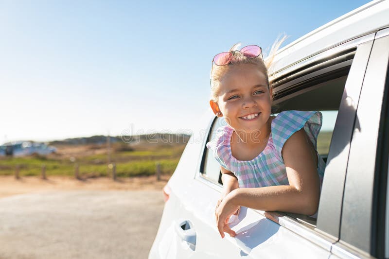 Cute girl looking out of car window.