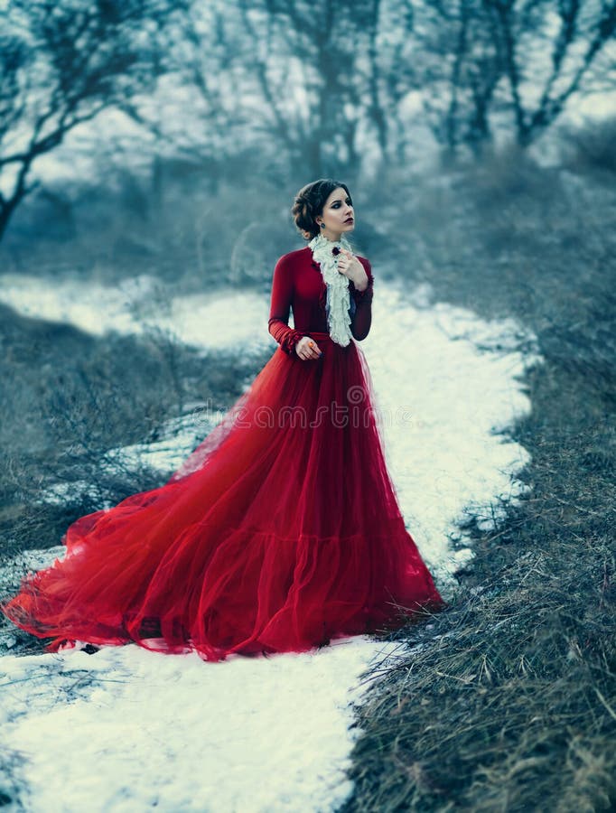 Cute girl in luxurious red dress. Fashionable toning