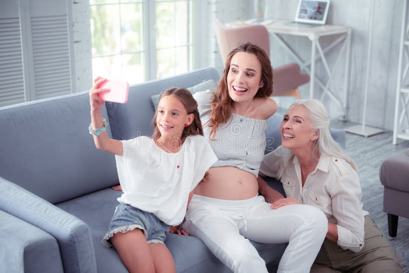 Cute girl making selfie with pregnant mother and grandmother royalty free stock images Cute girl making selfie with pregnant mother and grandmother royalty free stock images