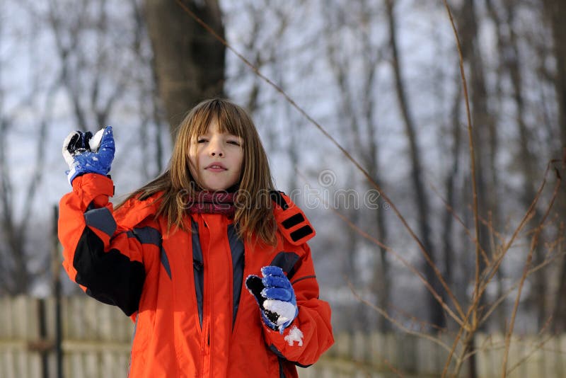 Cute girl making snowballs