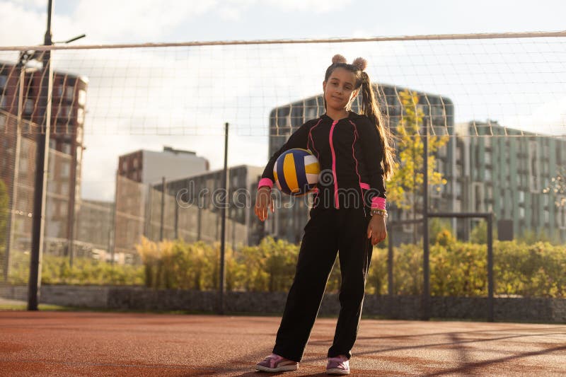 Cute Girl Playing Ball. Girl with a Blue-yellow Volleyball Stock Photo ...