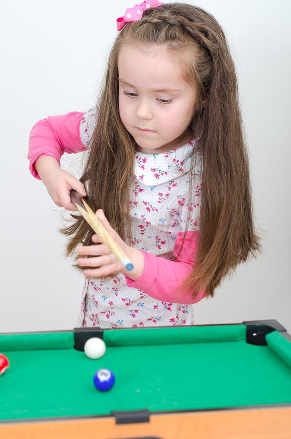 Cute girl playing billiard stock photo Cute girl playing billiard stock photo