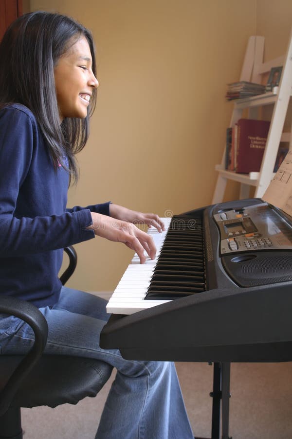 Cute girl playing piano