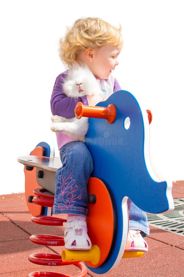 Cute girl and rabbit at the playground stock photo Cute girl and rabbit at the playground stock photo