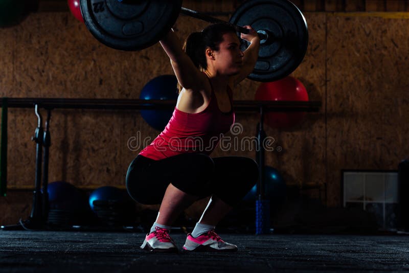 Cute girl raising barbell stock image. Image of muscle - 146194507