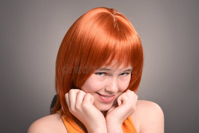 Portrait of Cute Girl with Red Hair Posing in Studio Stock Photo
