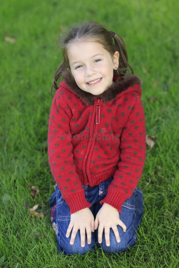 Cute girl relaxing on a grass