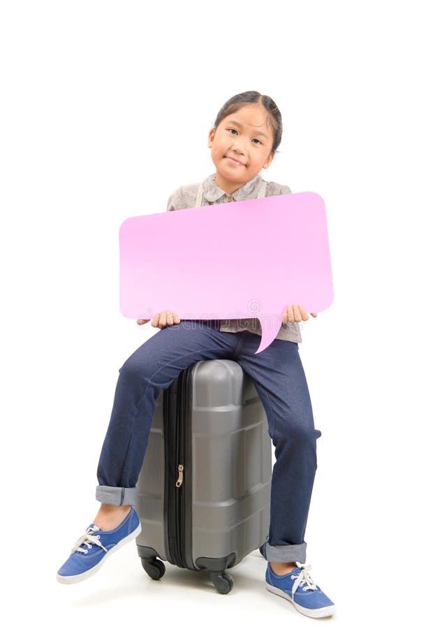 Cute girl traveler sit on suitcase and holding speech bubble stock image Cute girl traveler sit on suitcase and holding speech bubble stock image