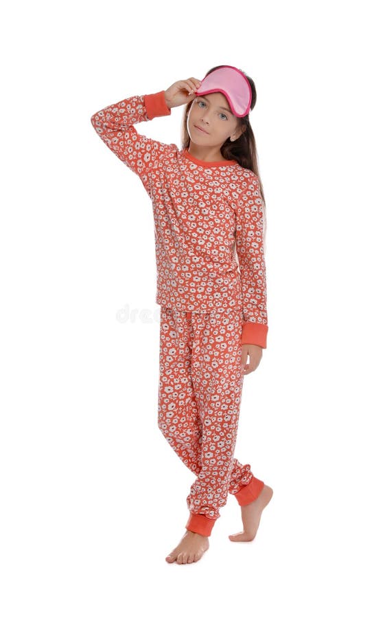 Cute girl wearing pajamas and sleeping mask on white background