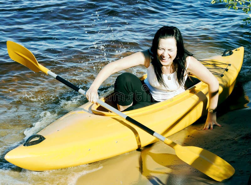Cute girl in a yellow kayak