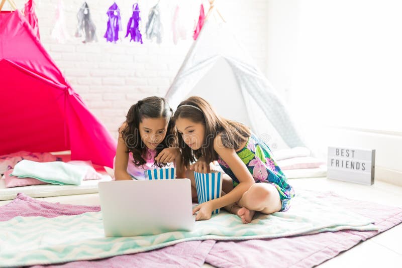 Cute Girls Enjoying Movie On Laptop During Sleepover Party stock photography Cute Girls Enjoying Movie On Laptop During Sleepover Party stock photography