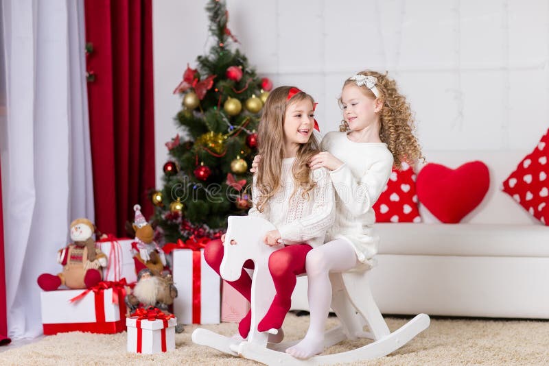 Cute girls playing in Christmas decorated room