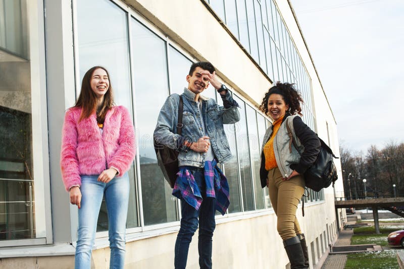Cute group of teenages at the building of university with books huggings, diversity nations real students lifestyle stock image Cute group of teenages at the building of university with books huggings, diversity nations real students lifestyle stock image