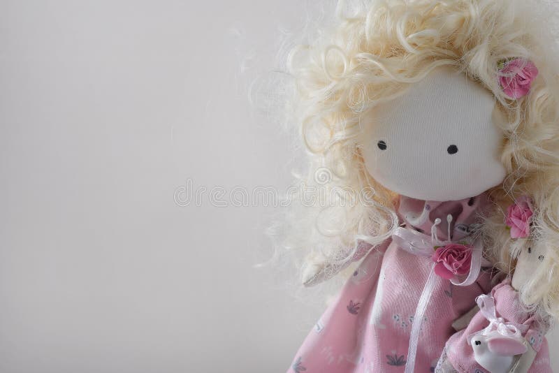 Cute handmade doll with blond curly-hair closeup with copyspace royalty free stock photos Cute handmade doll with blond curly-hair closeup with copyspace royalty free stock photos