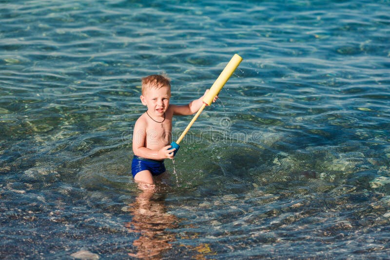Cute happy kid playing with water pistol royalty free stock images Cute happy kid playing with water pistol royalty free stock images