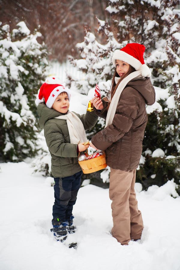 Cute Happy Kids, Boy and Girl in Santa Hats Decorate Christmas Tree in ...