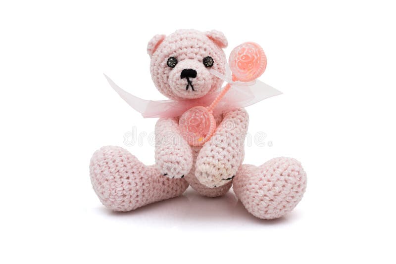 Cute homemade teddy bear with baby rattle stock photos