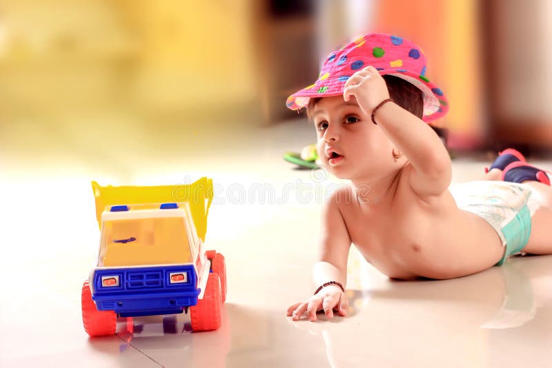 Cute Indian baby child playing with toy royalty free stock photos