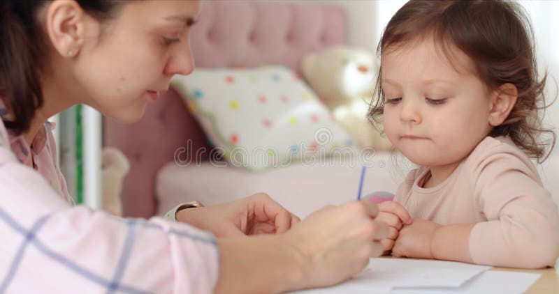 Cute Kind Mädchen mit Mutter Malerei zu Hause stock footage