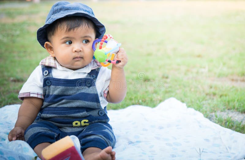 Cute little asian baby sitting in garden,vintage tone