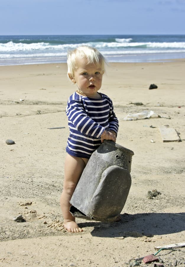 Cute little baby boy playing on the beach