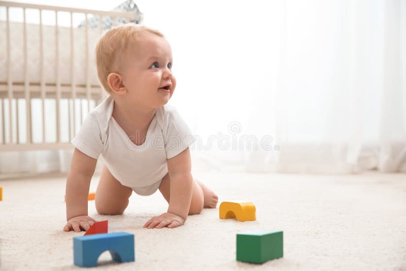 Cute little baby crawling on carpet indoors stock photography Cute little baby crawling on carpet indoors stock photography