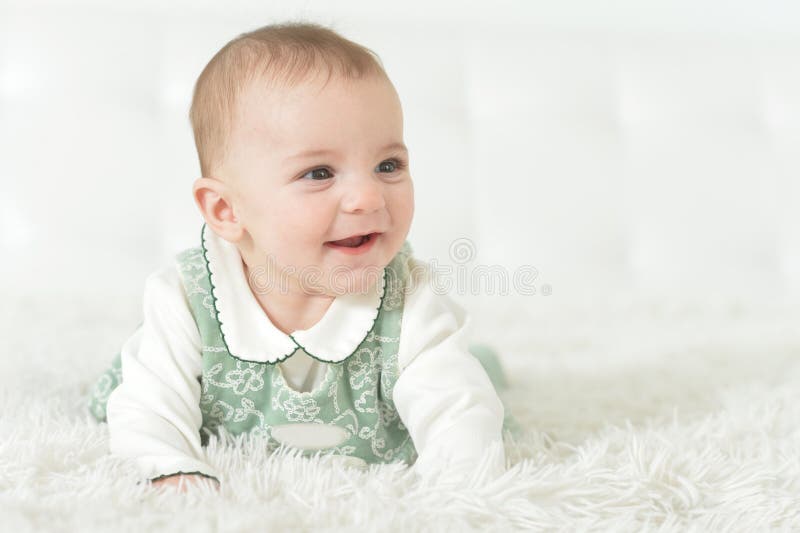 Cute little baby girl on white blanket