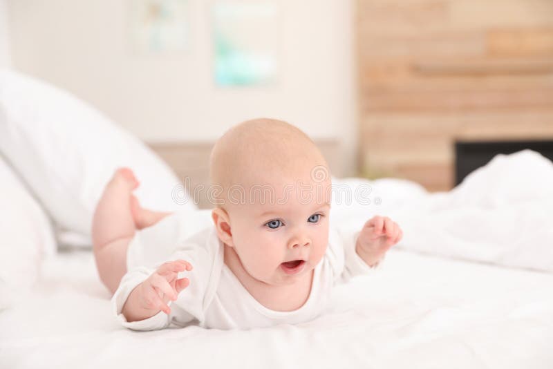 Cute Little Baby Lying on Bed Stock Photo Image of care, playful