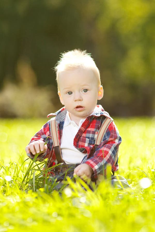 Cute Little Baby in the Park on the Grass. Sweet Baby Outdoors. Stock ...