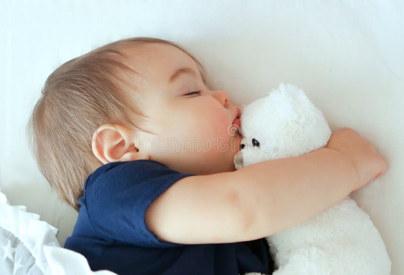 Baby sleeping with teddy bear