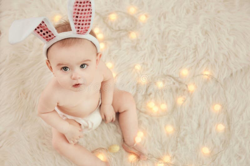 Cute little baby wearing bunny ears sitting on furry rug royalty free stock photos Cute little baby wearing bunny ears sitting on furry rug royalty free stock photos