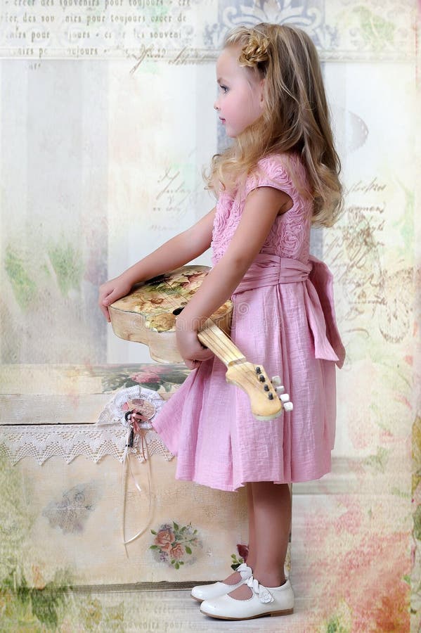 Little Blonde Girl In A Pink Dress With Curls And A Beautiful Hairstyle Stock Image Image Of 