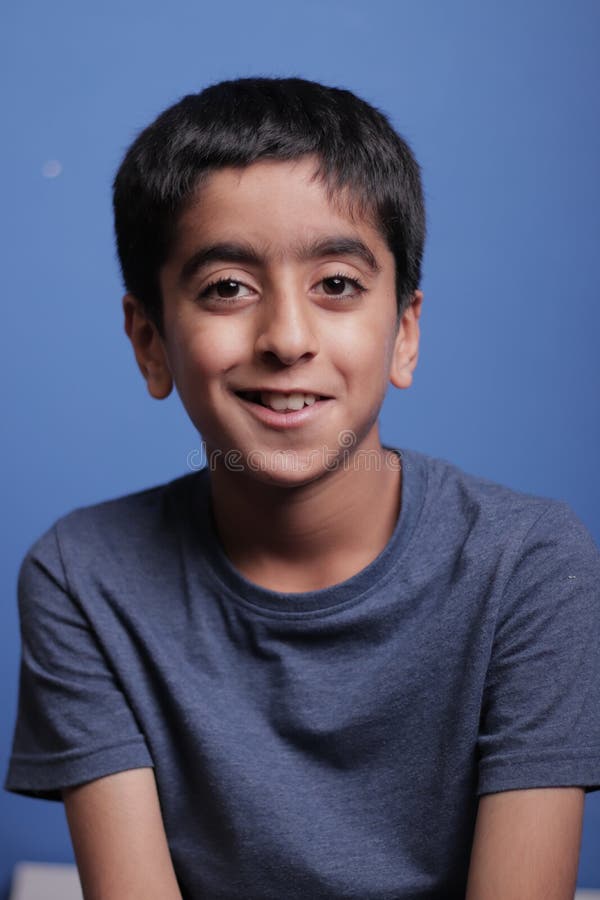 Cute little boy smilling on blue background