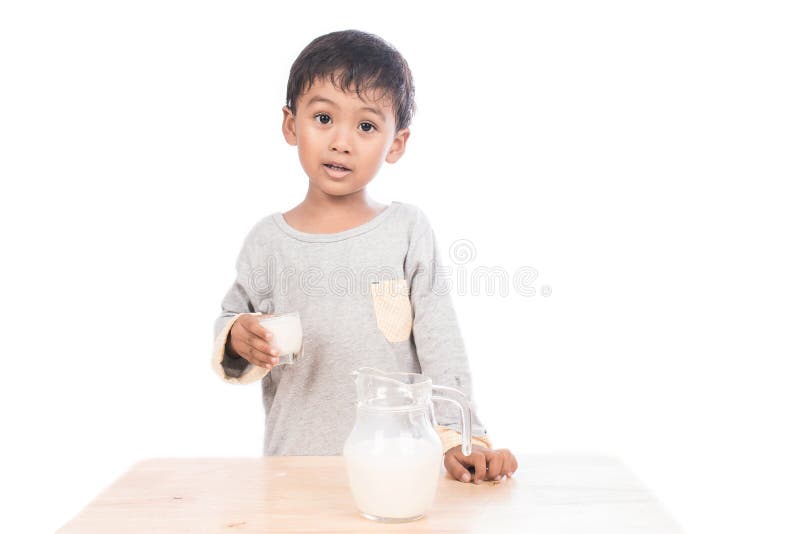 Cute little boy drinking milk royalty free stock photography