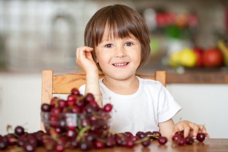 Cute Little Boy, Eating Cherries at Home in the Kitchen, Making Stock Image Image of funny