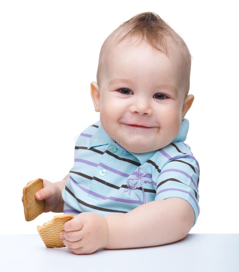 Cute little boy is holding cookies and smile royalty free stock photo Cute little boy is holding cookies and smile royalty free stock photo