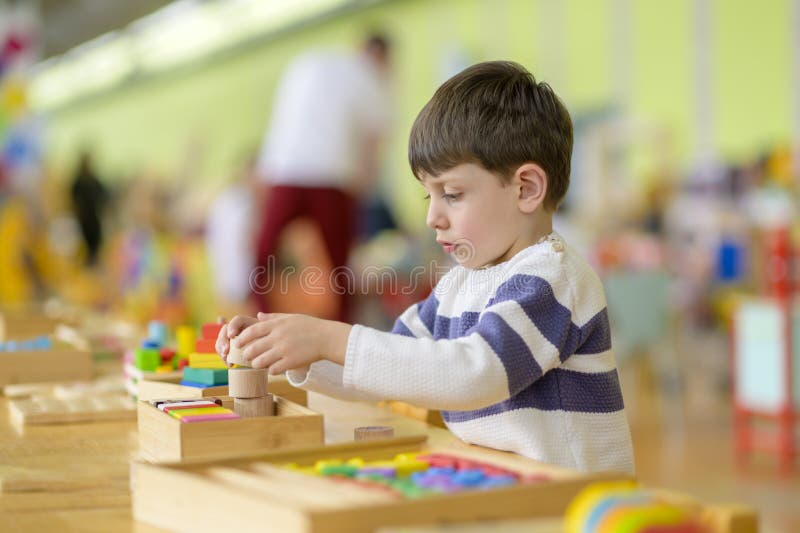 Cute Little Boy Playing at Kindergarten with Construction Toy Stock